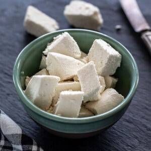 fresh homemade paneer placed in a blue color bowl