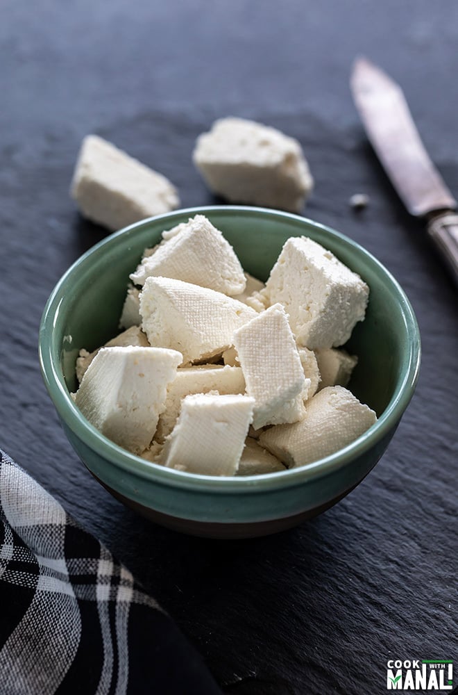 fresh homemade paneer placed in a blue color bowl