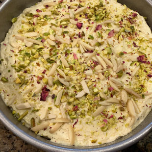 cake batter topped with pistachios, almonds and rose petals