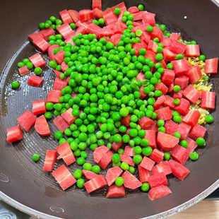 carrots and green peas added to a pan