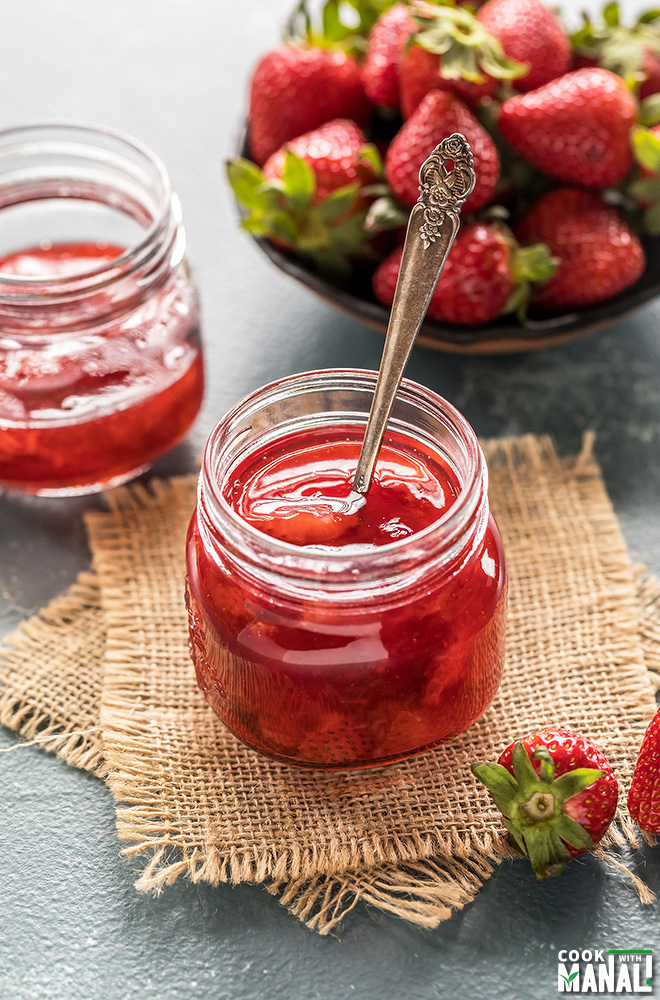 homemade strawberry syrup in a small jar with spoon