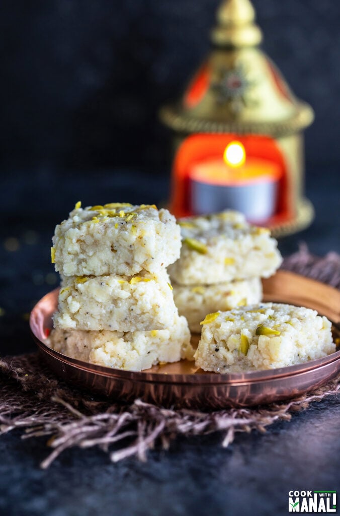 stack of 3 kalakand with tea light in the background