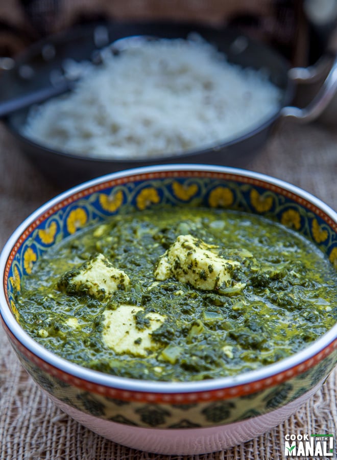 palak paneer served in a bowl with rice bowl in the background