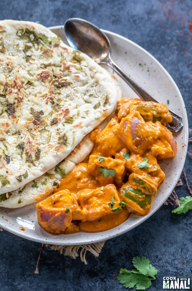 plate with naan and a paneer curry