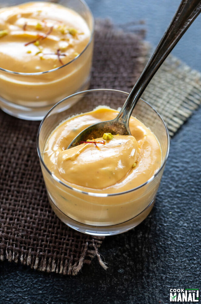 mango shrikhand served in a small glass jars garnished with saffron