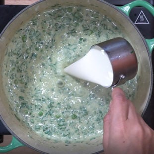 cream being added to a curry