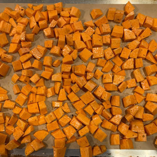 diced sweet potatoes placed on a baking tray