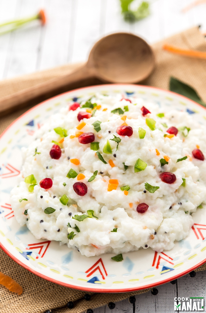 curd rice served in a white plate with a spatula in the background