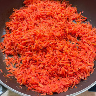 grated carrots in a pan