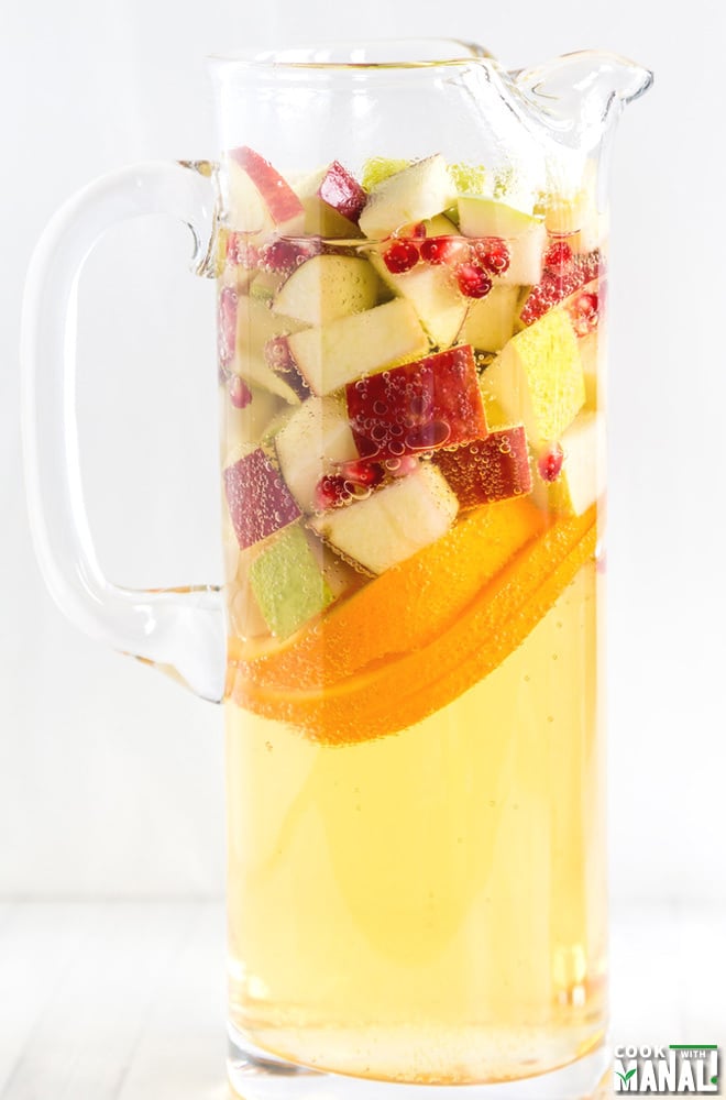 pitcher filled with a bubble drink and lots of fruits