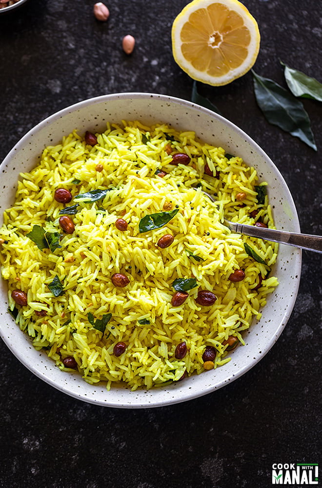 lemon rice served in a white bowl with a spoon