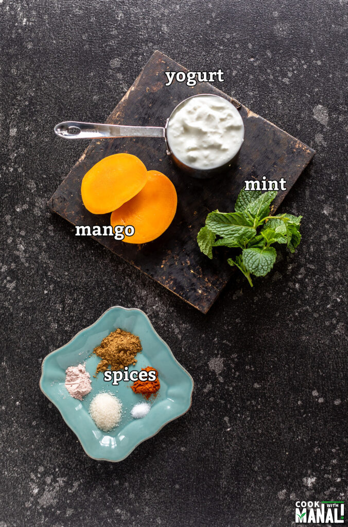 ingredients for mango mint raita arranged on a board