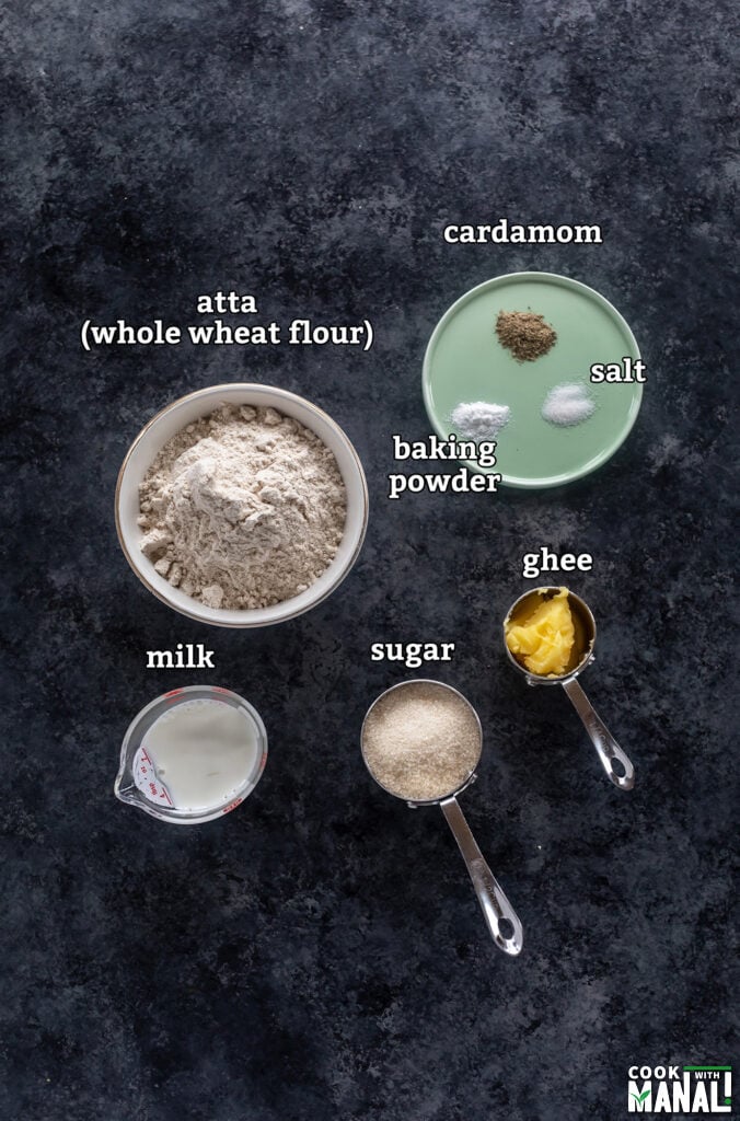 ingredients for making atta biscuits at home arranged on a board