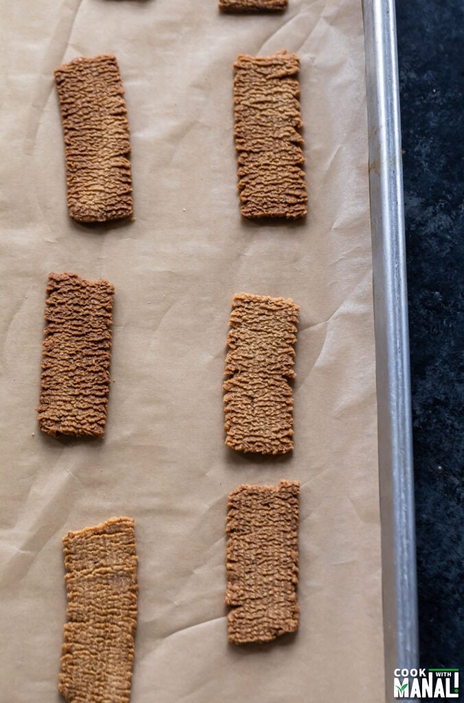 atta biscuits arranged on a baking tray