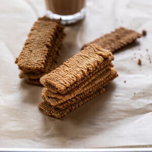 stack of atta biscuits with chai place in the background