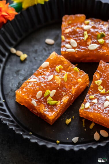 pieces of karachi halwa placed on a black plate