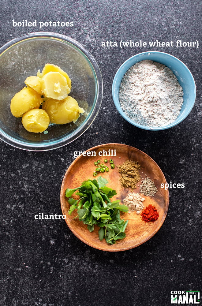 one bowl with boiled potatoes, one with flour and a plate with spices