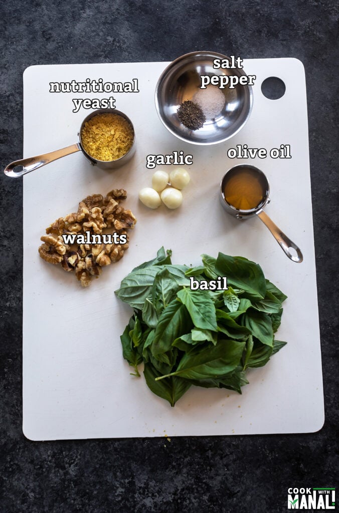 ingredients for vegan pesto arranged on a board
