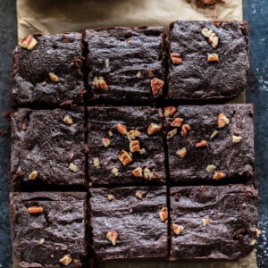 6 large pieces of brownies arranged on a parchment paper