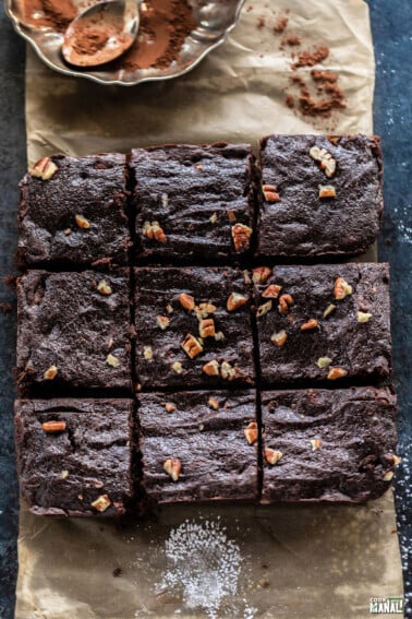 6 large pieces of brownies arranged on a parchment paper