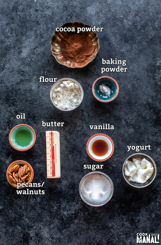 ingredients for making eggless brownies arranged on a board