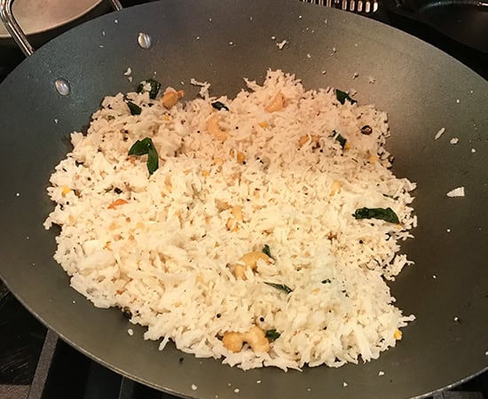 rice mixed with seasonings in a pan 