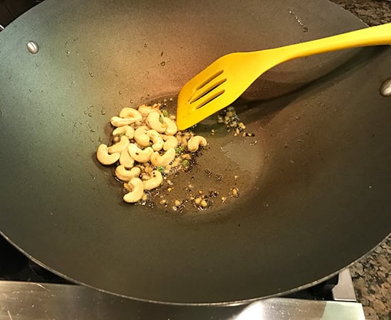 cashews with mustard seeds in a pan