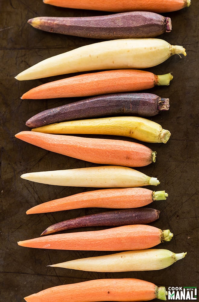 baby carrots lined on a baking tray