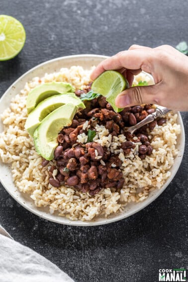 plate with beans and brown rice and avocado slices