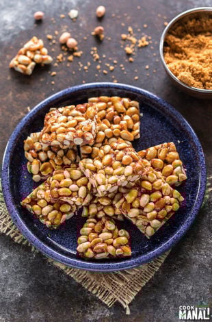 overhead shot of peanut chikki squares in a blue plate
