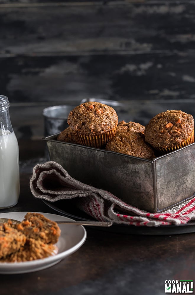 carrot muffins in a pan with a bottle of milk on the side