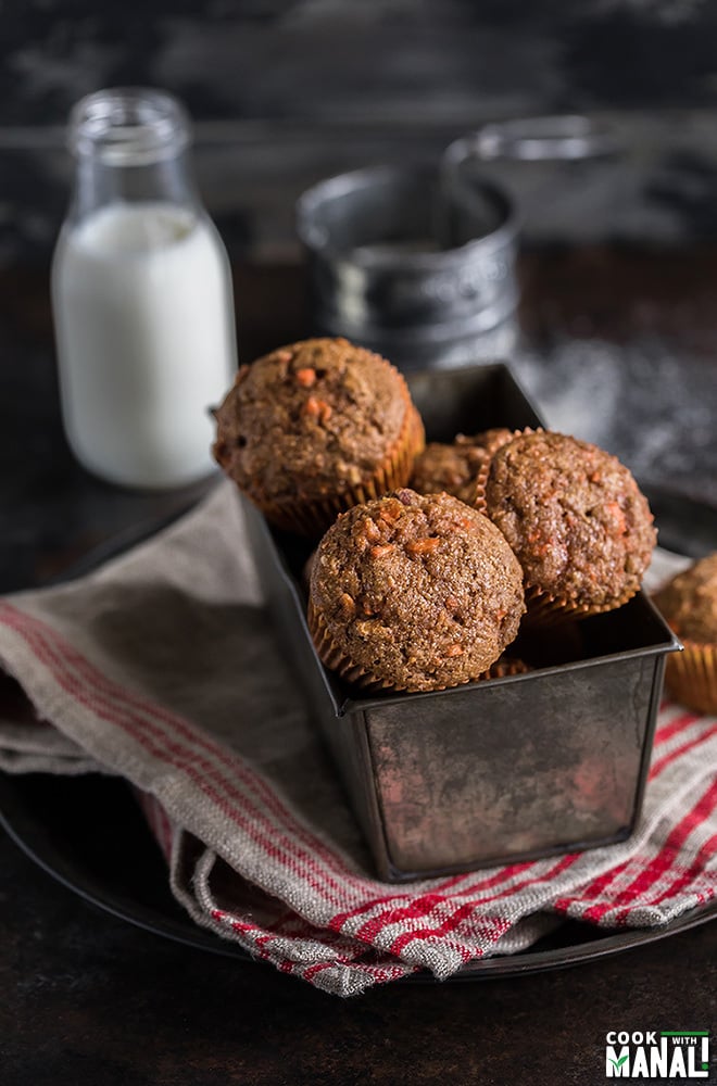 carrot muffins in a pan with a bottle of milk on the side