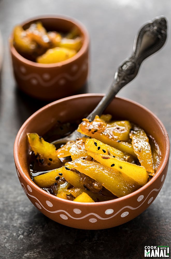 aam ki launji in a bowl with a spoon