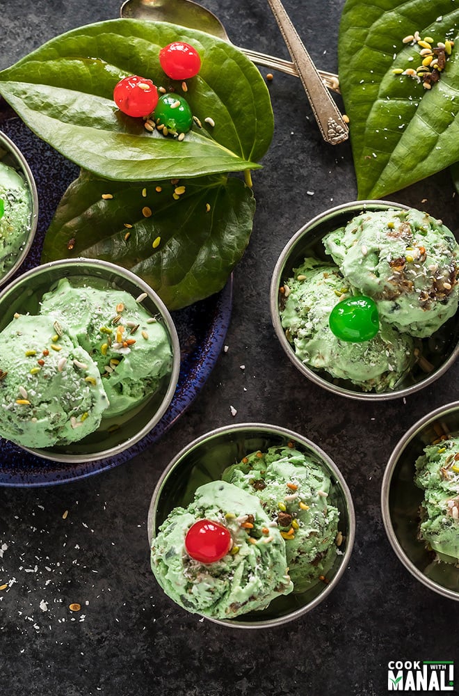 overhead shot of paan ice cream served in small copper bowls and garnished with coconut and cherries