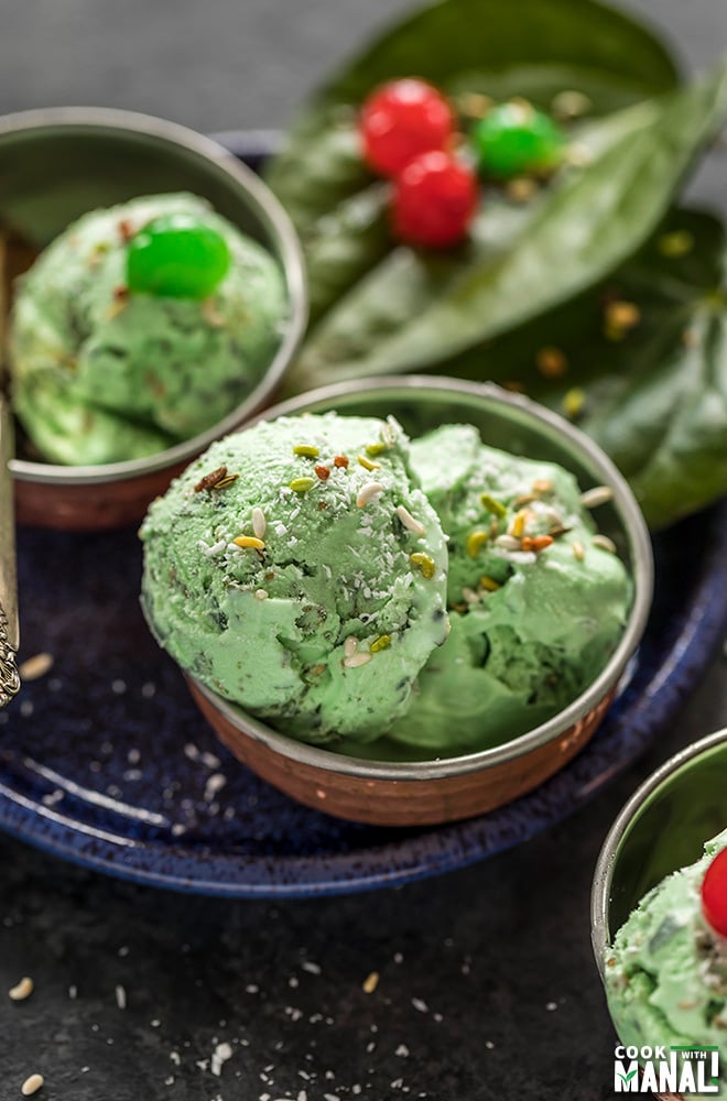 paan ice cream in small copper bowls and garnished with coconut and cherries