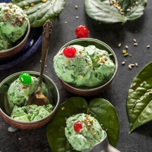 paan ice cream served in small copper bowls and garnished with coconut and cherries