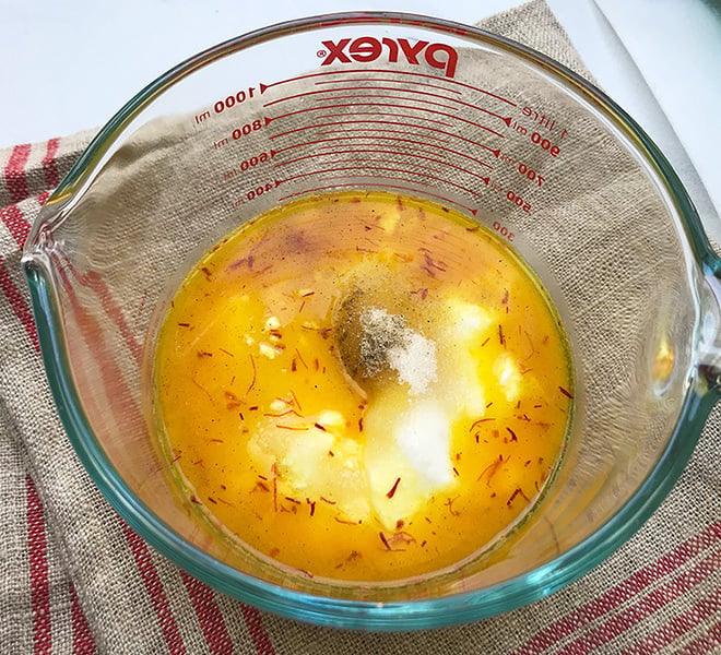 ingredients for saffron lassi in a large measuring jar