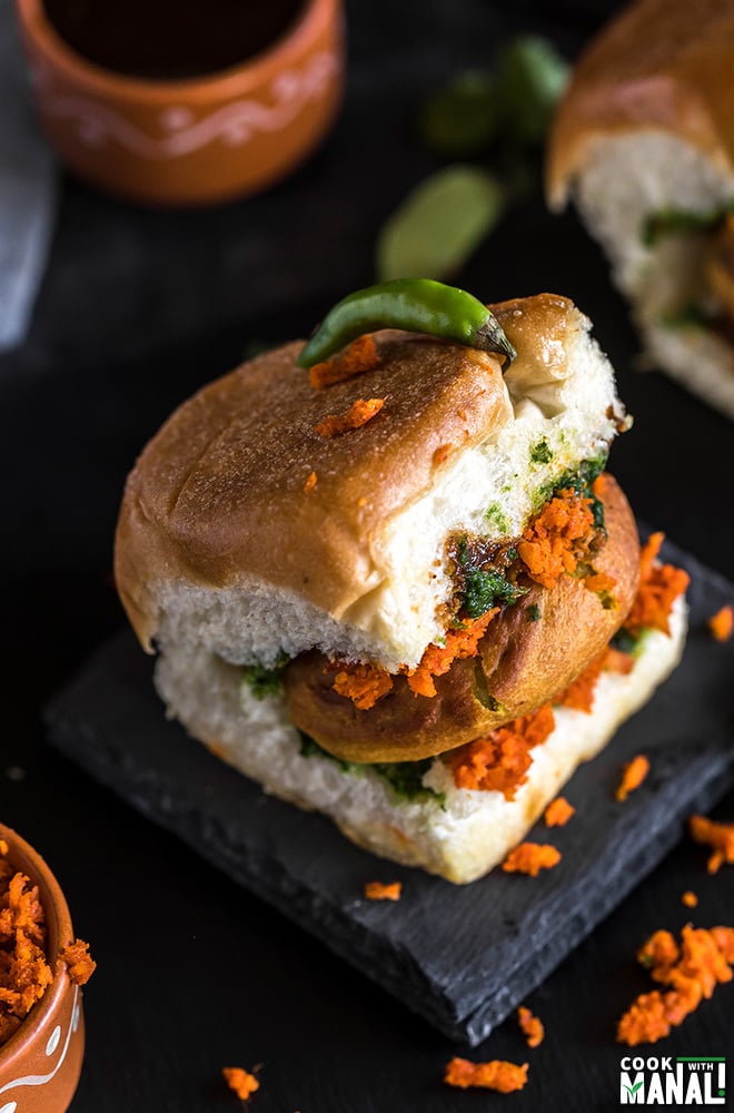 overhead shot of vada pav placed on a black coaster