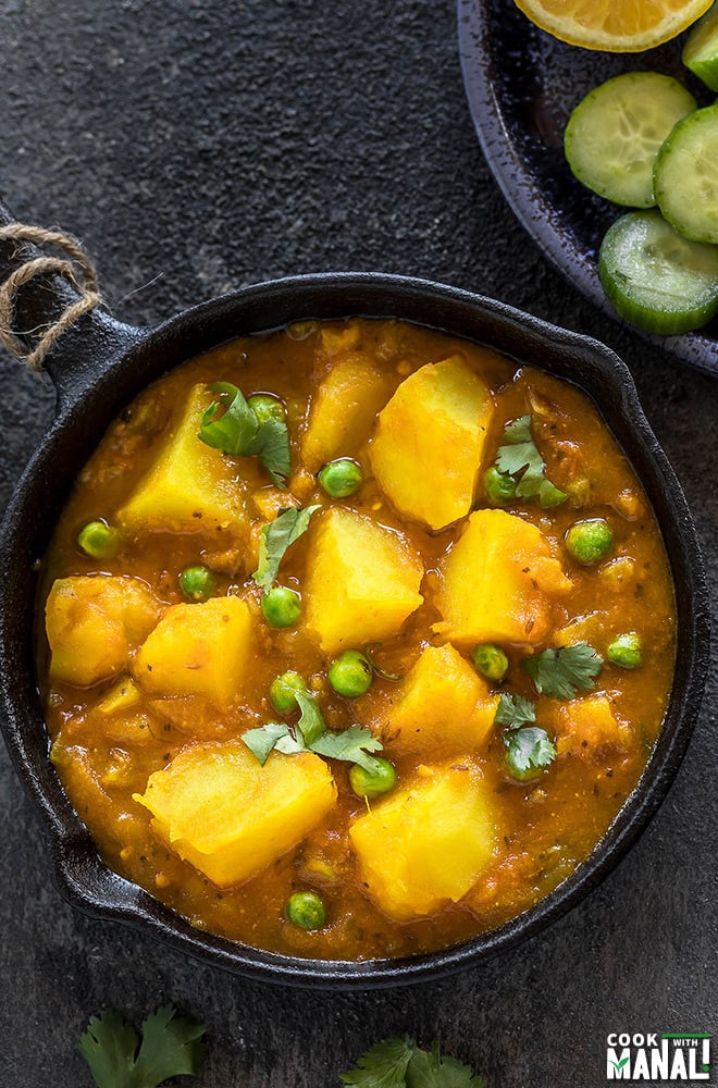 instant pot aloo matar served in a small black skillet