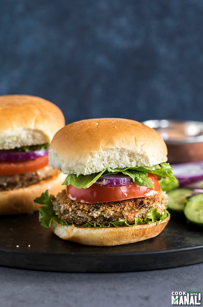 vegetarian burger with tomato, lettuce on a brown plate