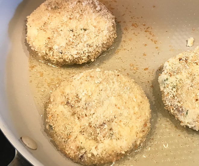 burger patties getting fried in hot oil