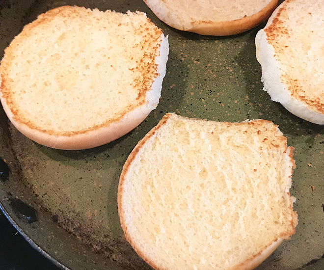 burger buns bring heated on a pan