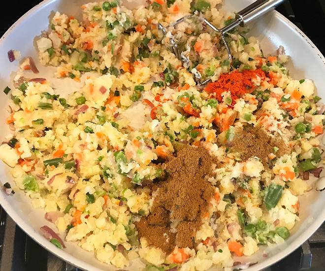 mashed veggies with spices in a pan