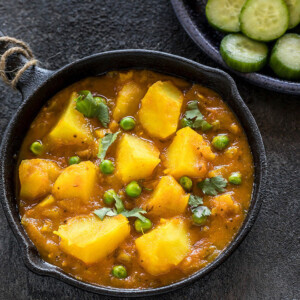 instant pot aloo matar served in a small black skillet