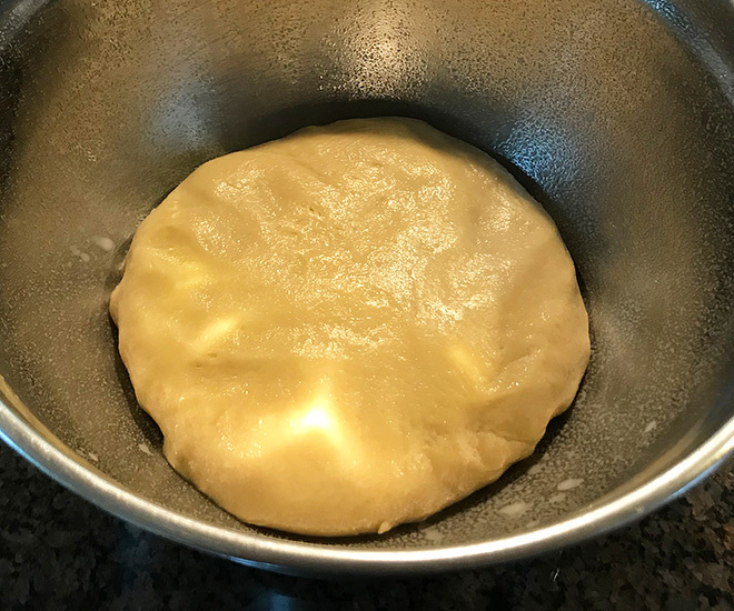 brioche dough in a steel bowl