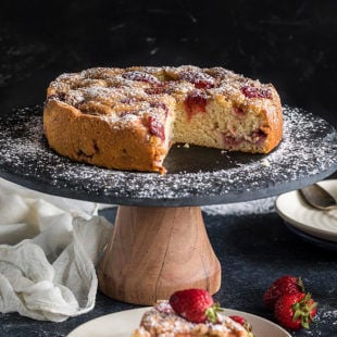 sliced strawberry cake on a black cake stand