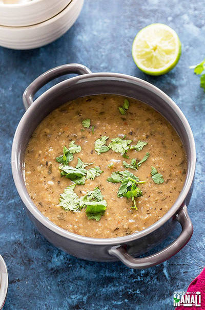 mediterranean lentil soup in a grey bowl and garnished with cilantro