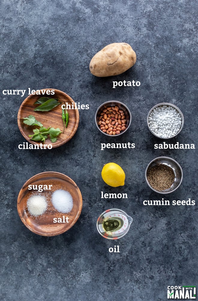 potato, lemon, bowl with peanuts, cumin seeds, sago pearls, lemon all arranged on a board