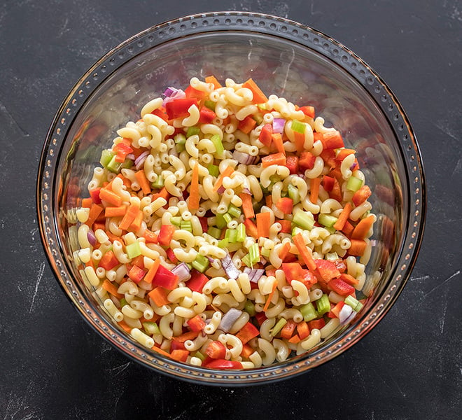 a bowl with boiled macaroni and chopped veggies