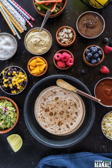 rotimatic roti with different toppings in small bowls for a roti party